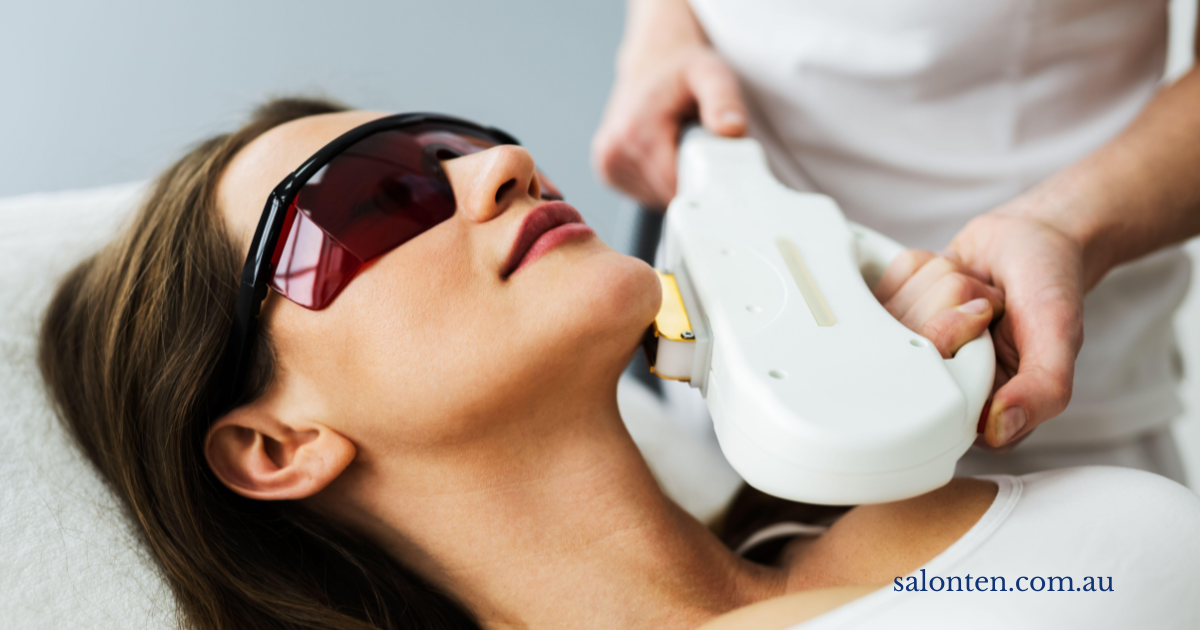 Light treatment being applied along the jawline, with the client wearing protective eyewear
